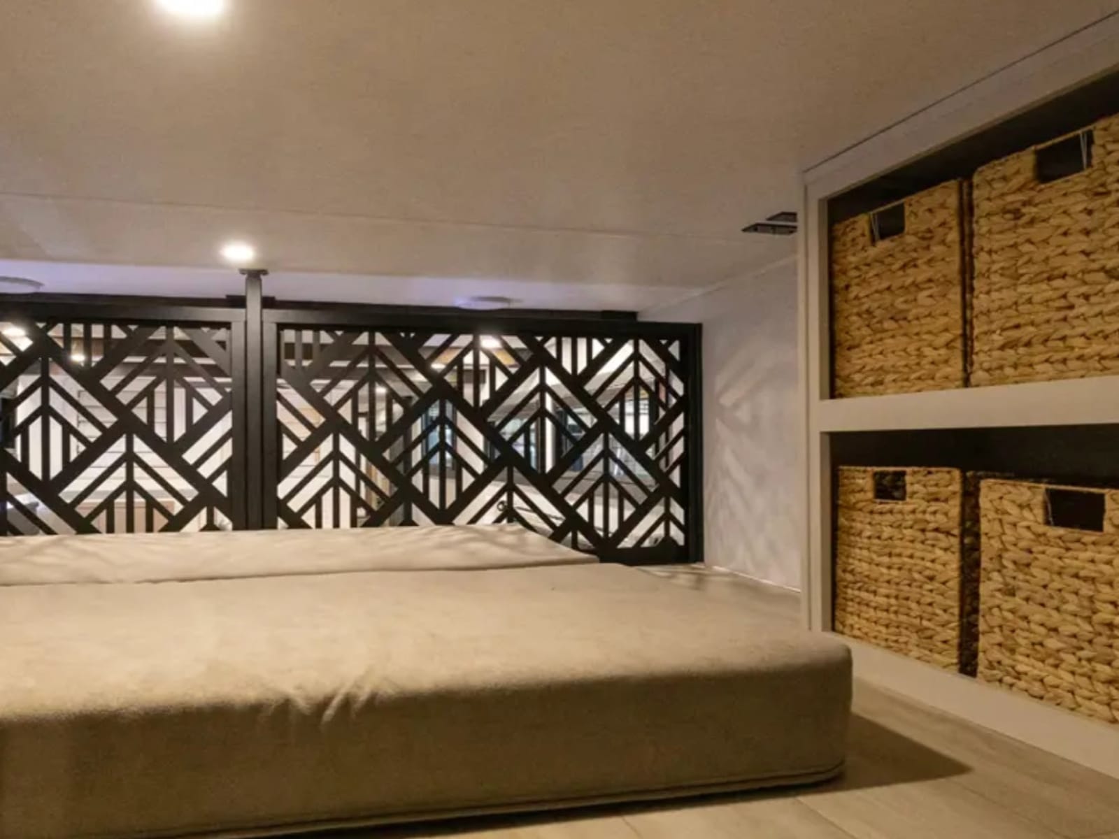 Loft bunkhouse bed with slatted partition and basket storage