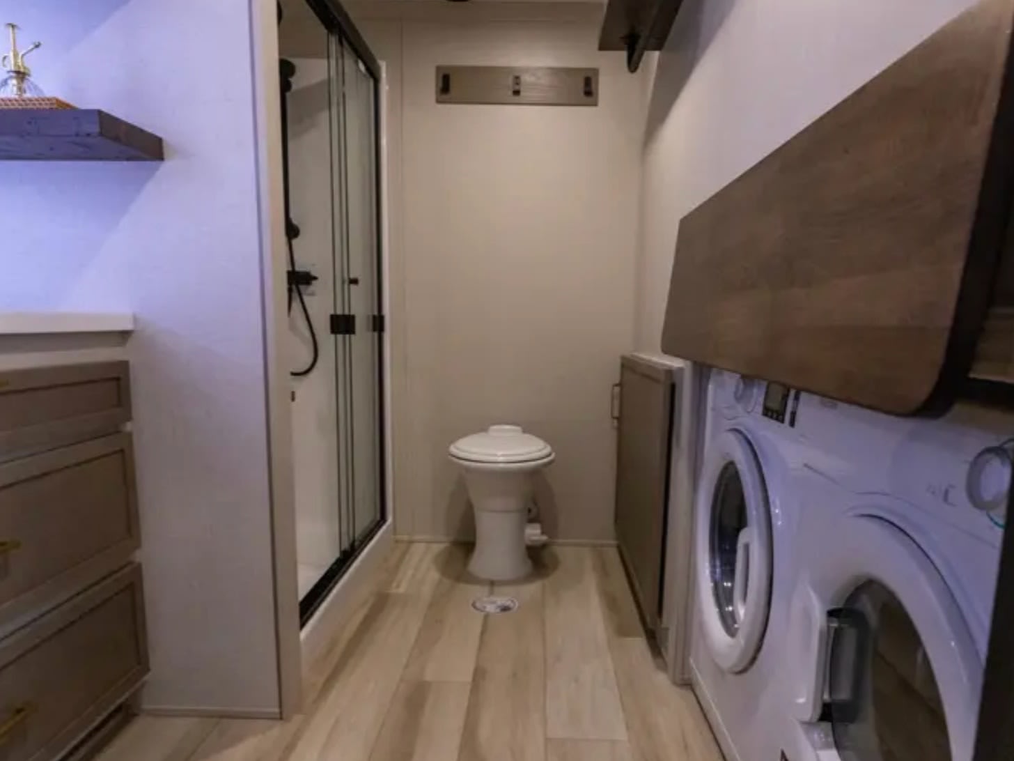Bathroom with toilet beside the washer and dryer