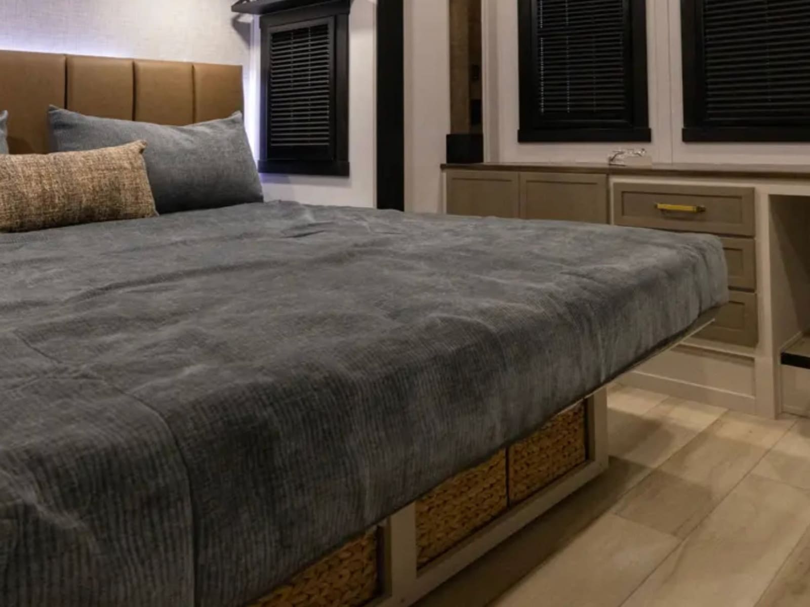 King bed in the master suite with windows and storage