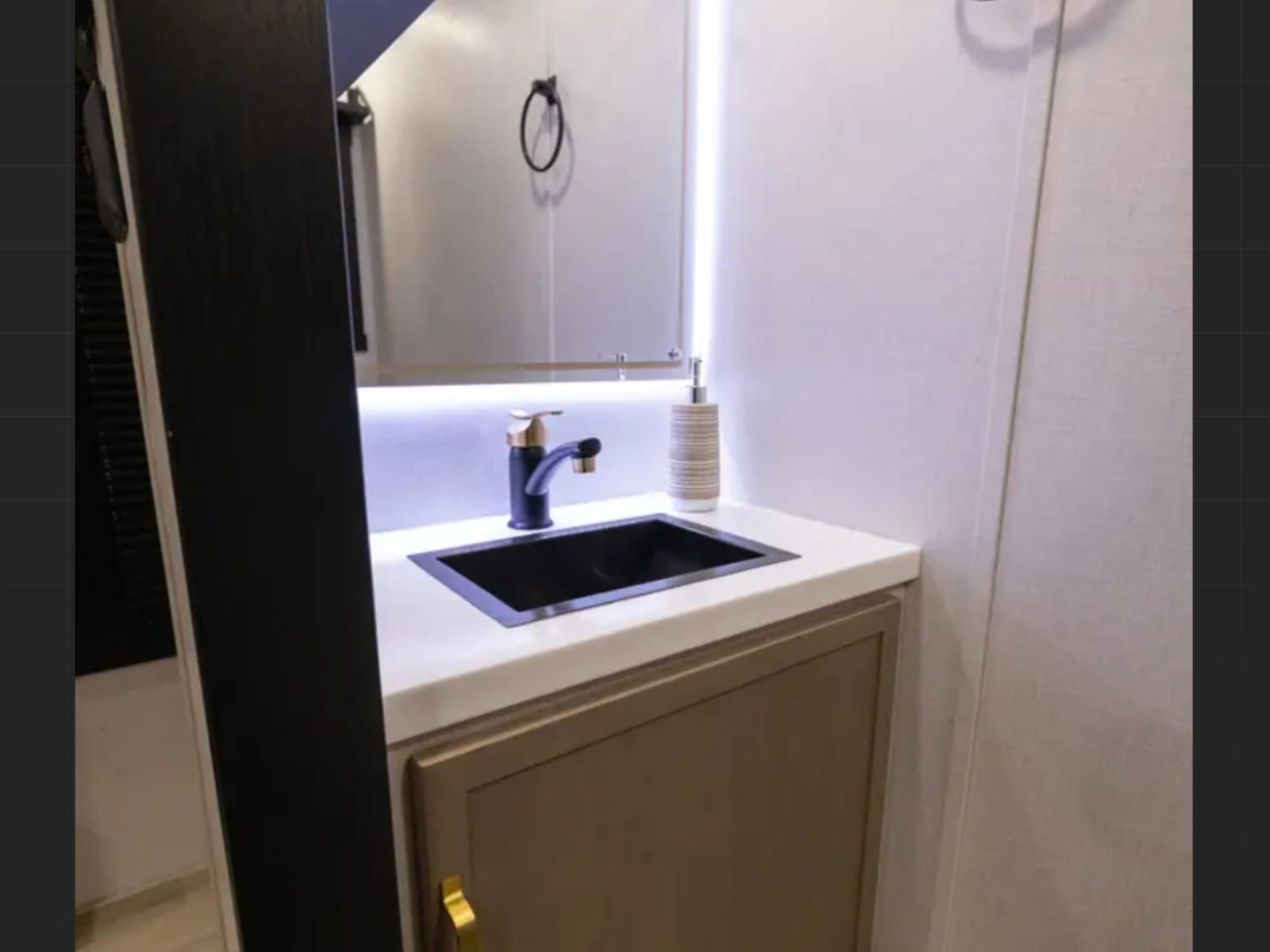 Second vanity with backlit mirror
